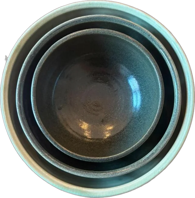 Three nesting bowls in deep green glaze, seen from above